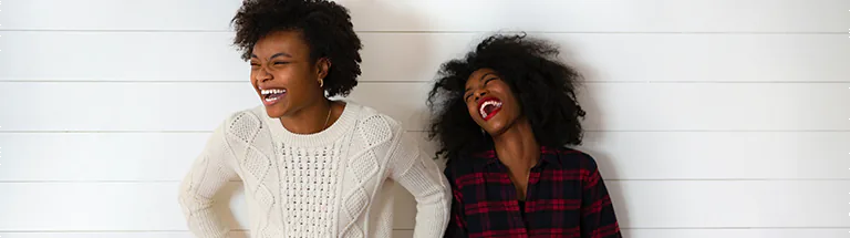 Two young black women laughing